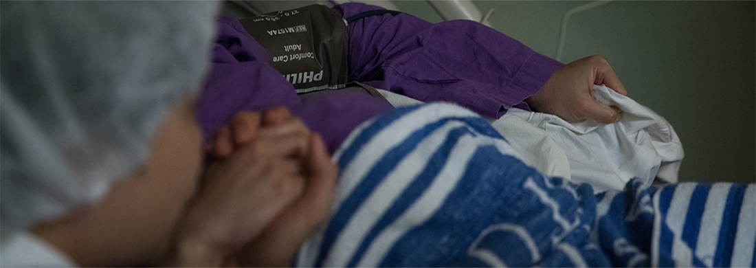 Patient and doctor holding hands